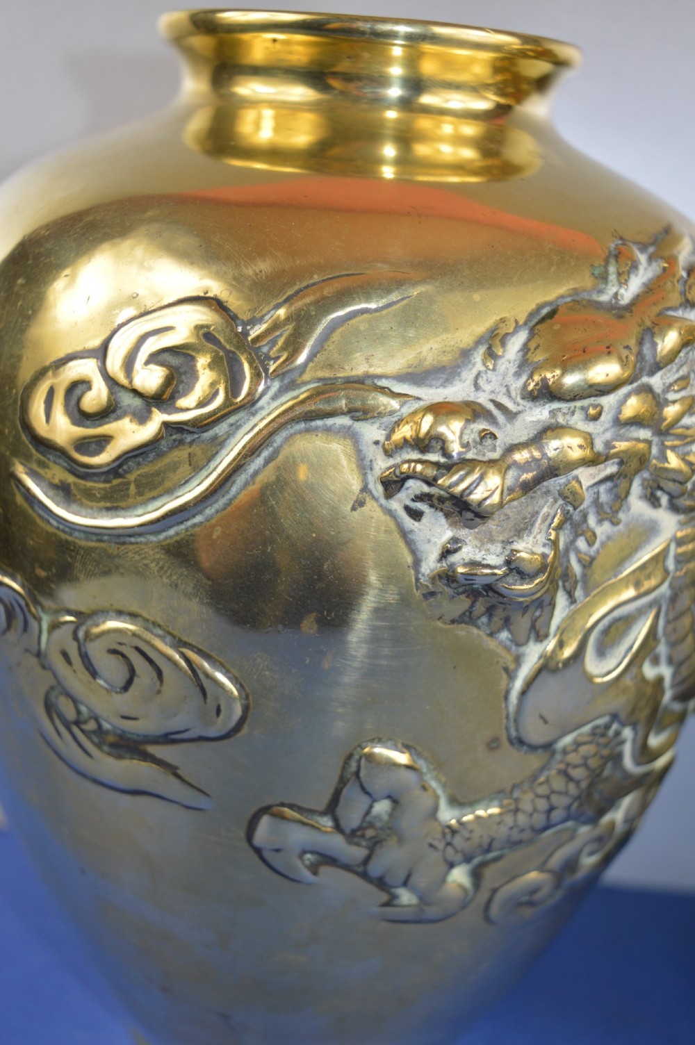 A matching pair of heavy polished gold gilt bronze baluster vases featuring carved high-relief dragons amid swirling cloud motifs. View XII