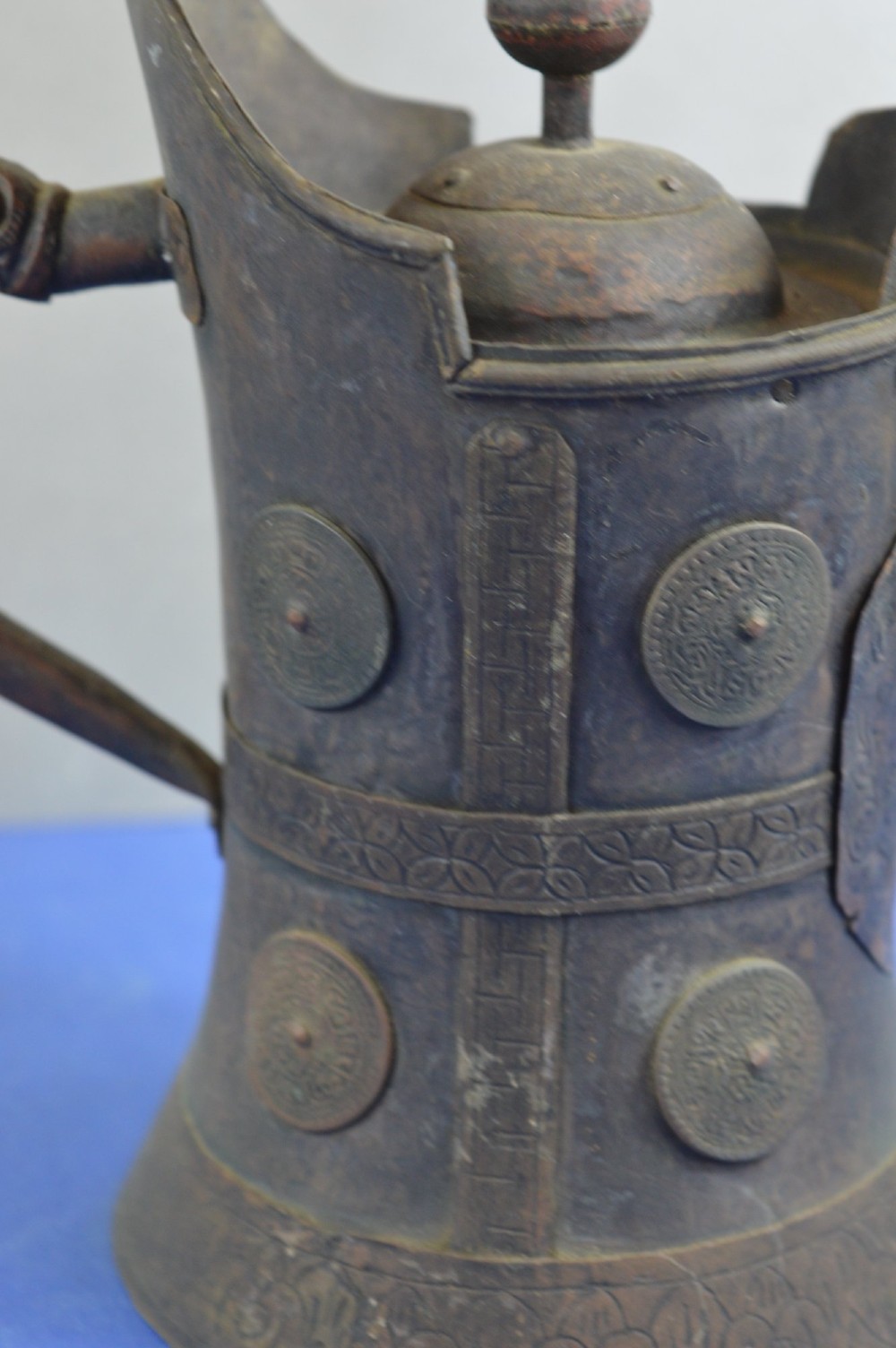 A pair of 19th-century Tibetan metal vessels comprising a squat copper pot with a snow lion lid and a tall cylindrical brass ewer with a dragon spout. View VIII