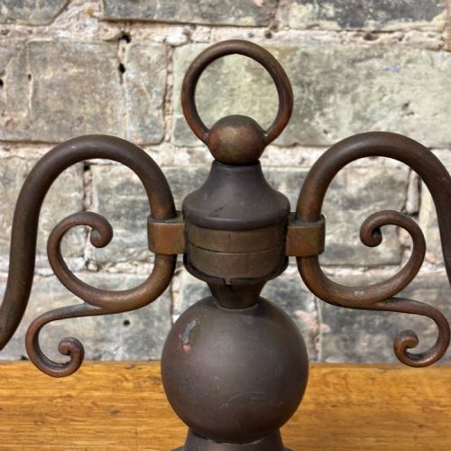 fig 1. An early 20th-century patinated brass two-arm candelabra table lamp featuring curved scroll arms, faux candle sleeves, and a stepped circular base.