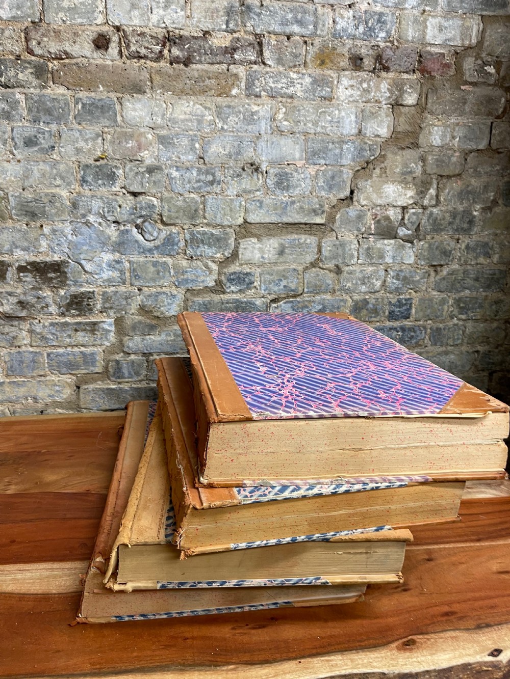 A large mid-20th-century bound archive volume of the Manchester Evening News featuring a tan leather spine with gilt lettering and marbled paper covers. View II