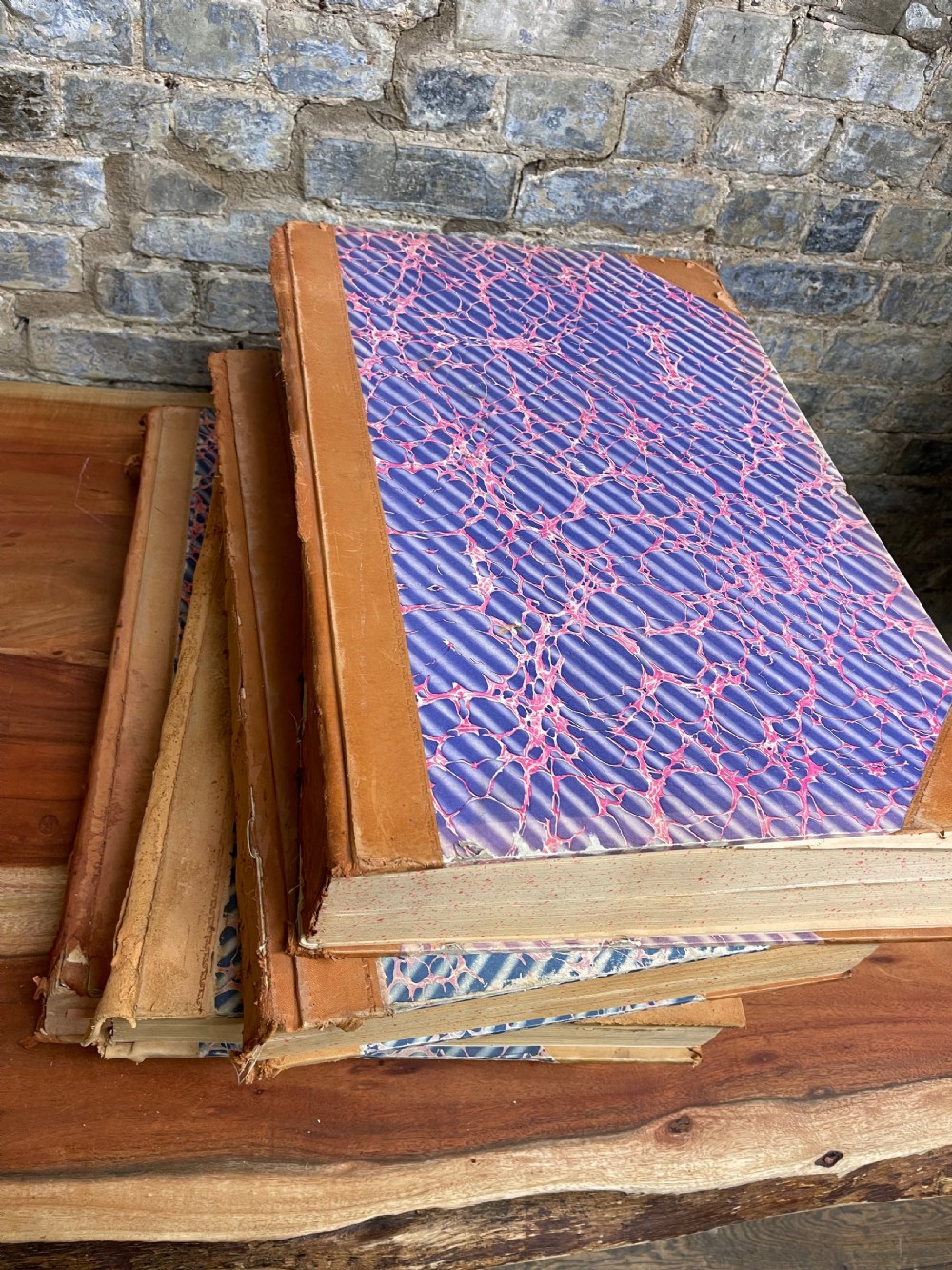 A large mid-20th-century bound archive volume of the Manchester Evening News featuring a tan leather spine with gilt lettering and marbled paper covers. View III