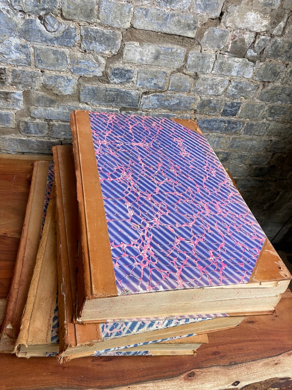 A large mid-20th-century bound archive volume of the Manchester Evening News featuring a tan leather spine with gilt lettering and marbled paper covers. View IV
