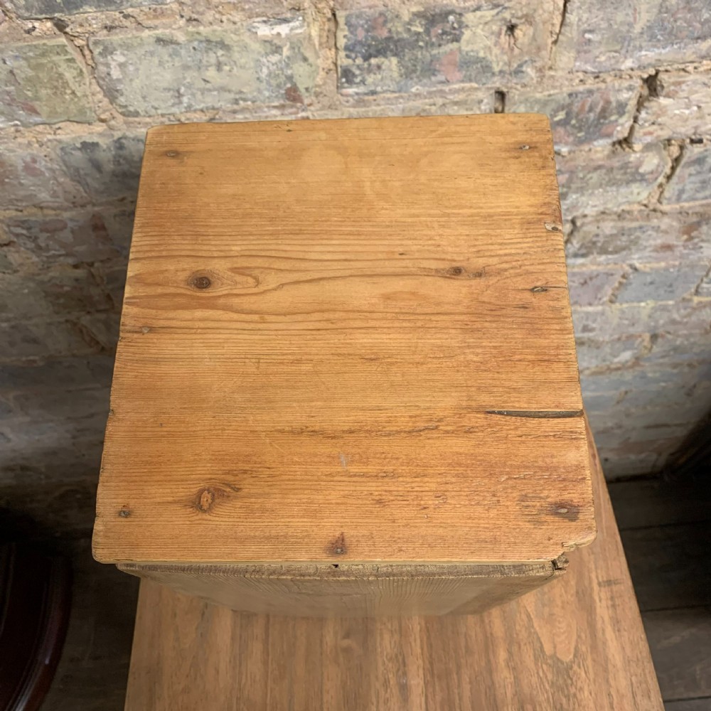 A small tabletop pine cabinet with four stacked drawers, each fitted with a round brass knob. View VIII