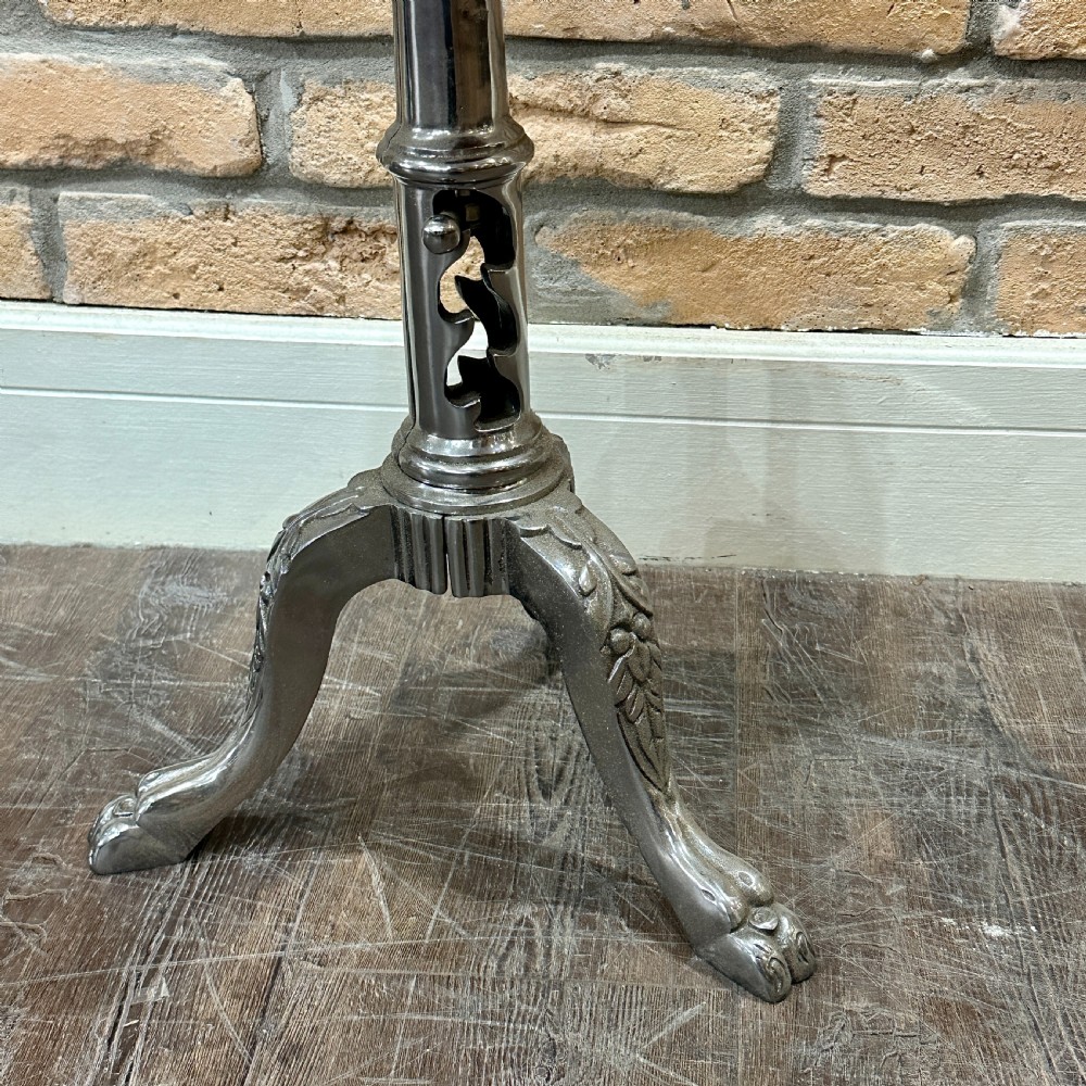 A Victorian industrial style height-adjustable stool featuring a dark round wooden seat resting on a silver-coloured cast metal tripod stem with ornate claw feet. View III