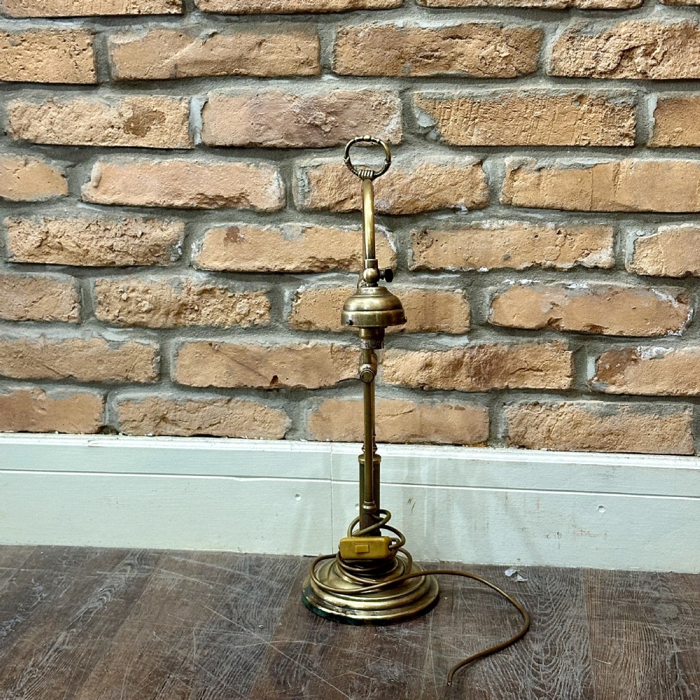 A vintage brass swan neck desk lamp featuring an adjustable curved arm, stepped circular base, and turned fitting details. View II