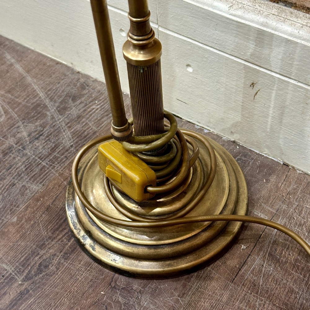 A vintage brass swan neck desk lamp featuring an adjustable curved arm, stepped circular base, and turned fitting details. View IV