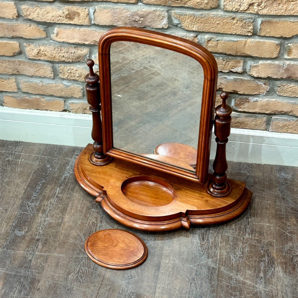 A Victorian mahogany swivel toilet mirror with turned side columns and a sculpted plinth base featuring an oval tray. View II