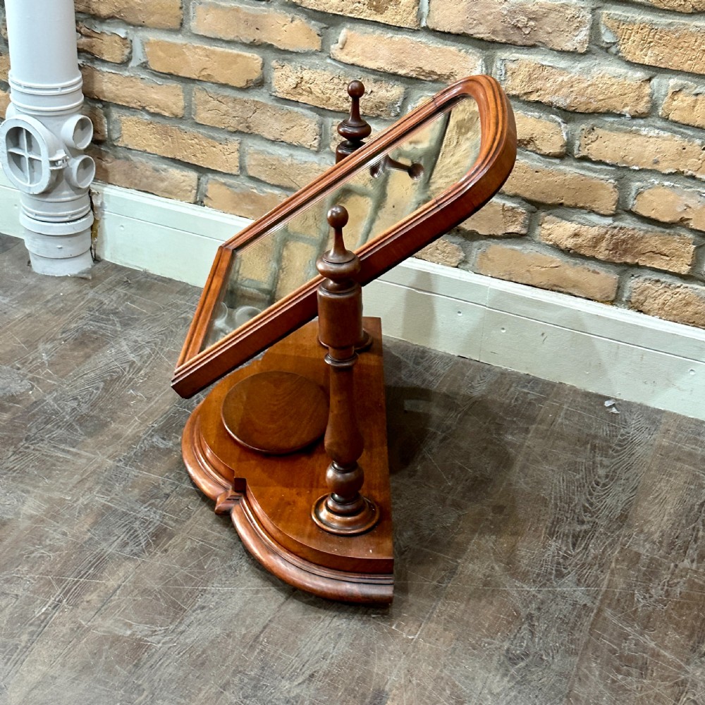 A Victorian mahogany swivel toilet mirror with turned side columns and a sculpted plinth base featuring an oval tray. View III