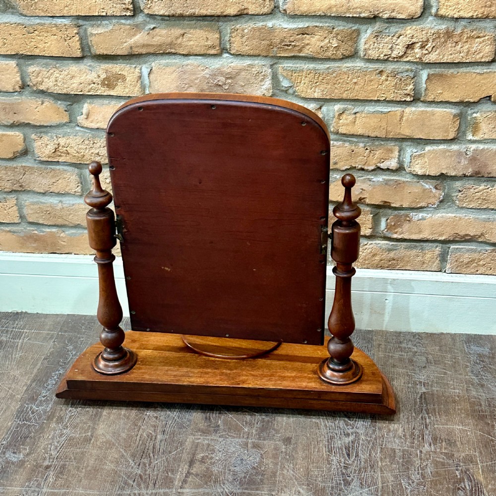 A Victorian mahogany swivel toilet mirror with turned side columns and a sculpted plinth base featuring an oval tray. View IV