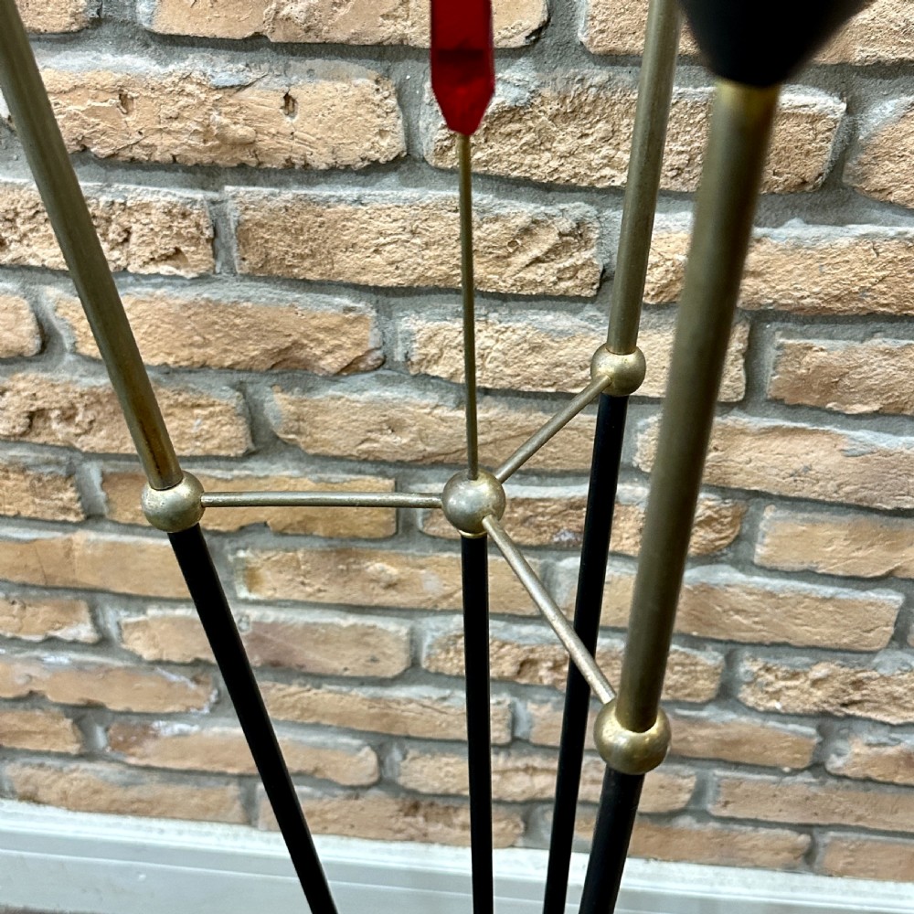 A mid-century French modernist floor lamp featuring three angled black and brass stems terminating in cone-shaped socket holders set upon a circular base. View III