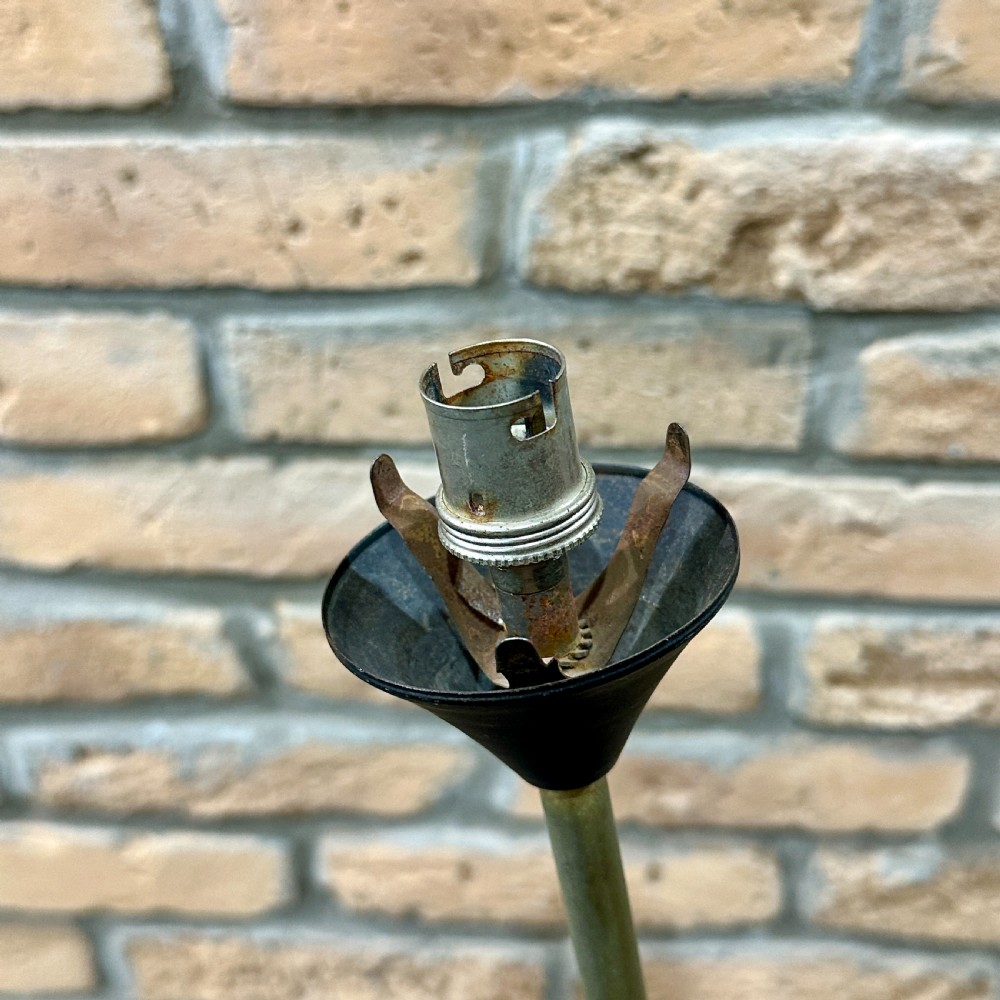 A mid-century French modernist floor lamp featuring three angled black and brass stems terminating in cone-shaped socket holders set upon a circular base. View V
