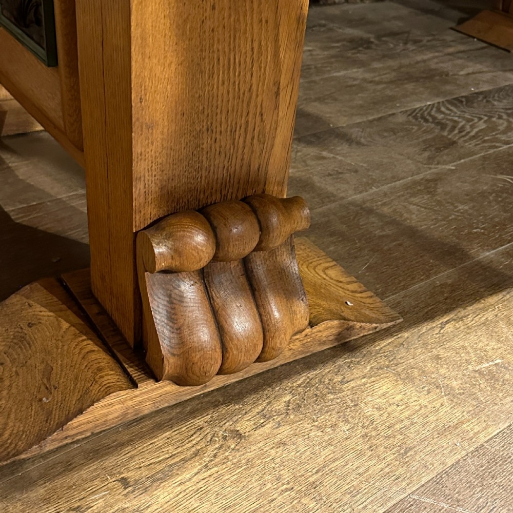 A large rectangular French Art Deco dining table featuring a geometric parquetry top and sturdy carved supports. View II