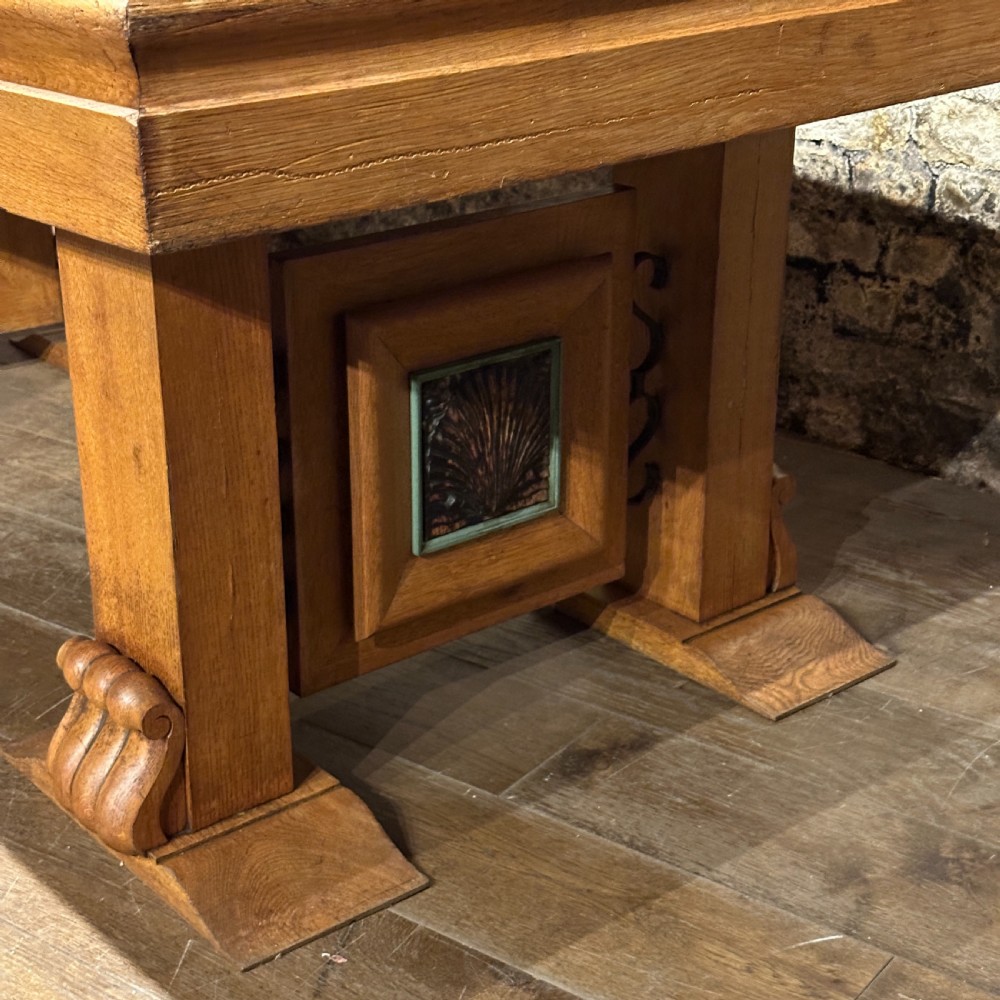 A large rectangular French Art Deco dining table featuring a geometric parquetry top and sturdy carved supports. View III