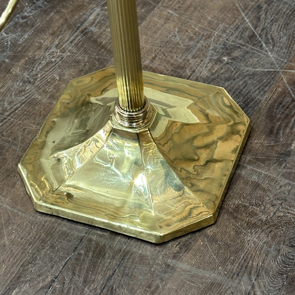 A polished brass multi-arm countertop hat stand featuring a reeded central column, six curved display arms, and a weighted octagonal base. View II