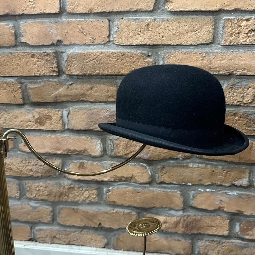 A polished brass multi-arm countertop hat stand featuring a reeded central column, six curved display arms, and a weighted octagonal base. View IV
