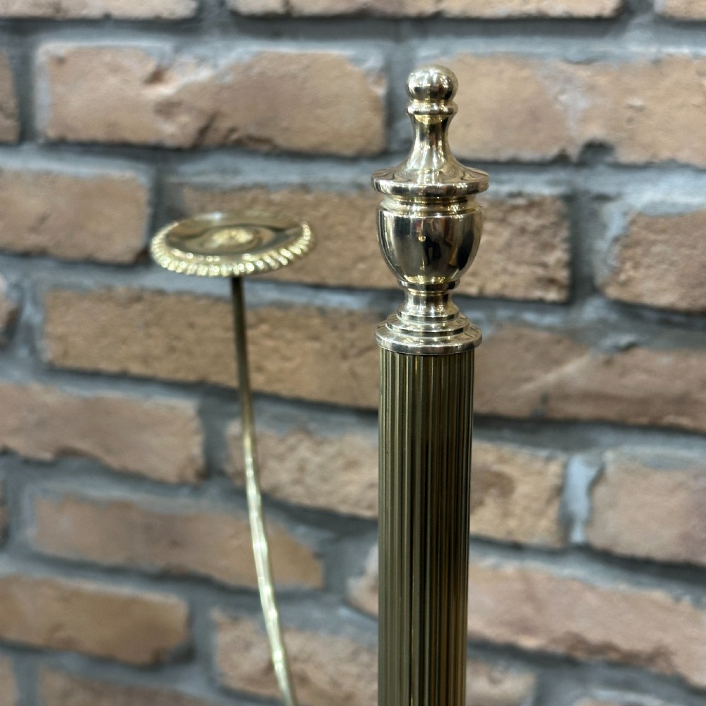 A polished brass multi-arm countertop hat stand featuring a reeded central column, six curved display arms, and a weighted octagonal base. View V