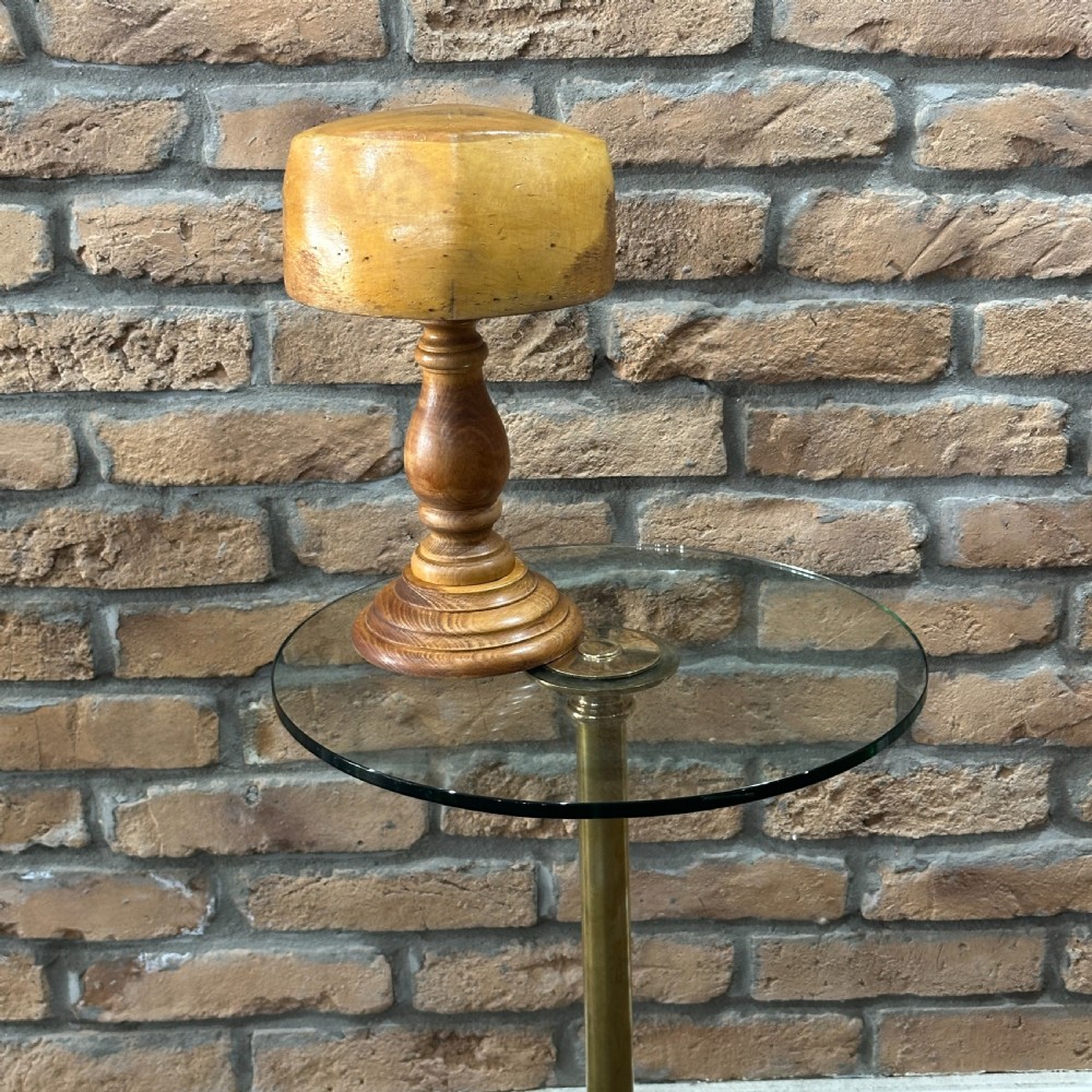 A solid turned beechwood hat block mounted on a turned pedestal and circular stepped base. View IV