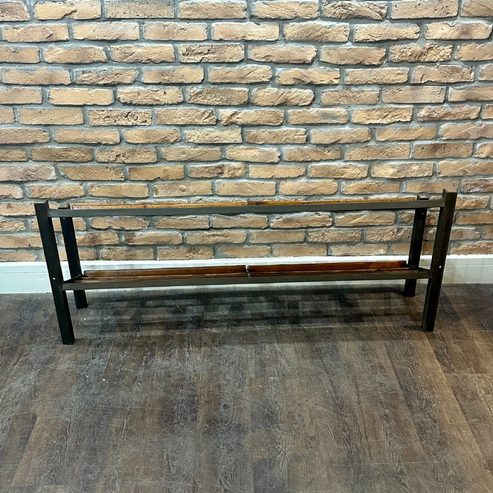 A two-tier vintage shop display counter featuring slatted oak shelves set within a dark metal frame with bronze detailing. View III