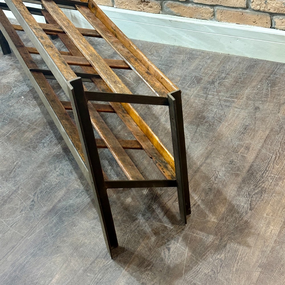 A two-tier vintage shop display counter featuring slatted oak shelves set within a dark metal frame with bronze detailing. View IV