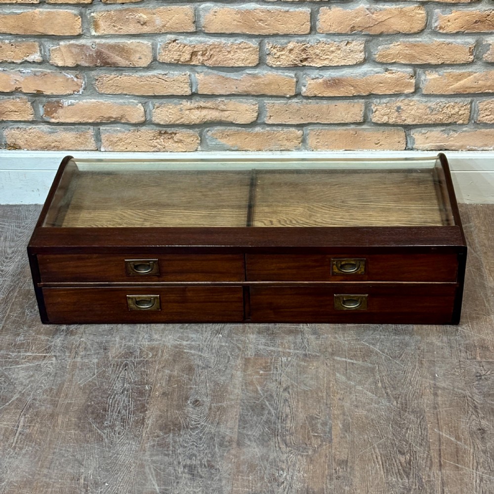 A Victorian mahogany countertop display cabinet featuring a curved glass front and a lower white panel reading Homoeopathic Medicines and Preparations. View V
