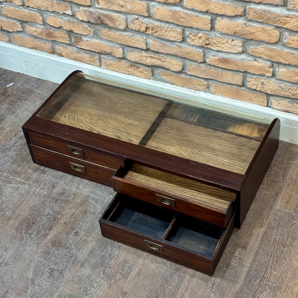 A Victorian mahogany countertop display cabinet featuring a curved glass front and a lower white panel reading Homoeopathic Medicines and Preparations. View VI