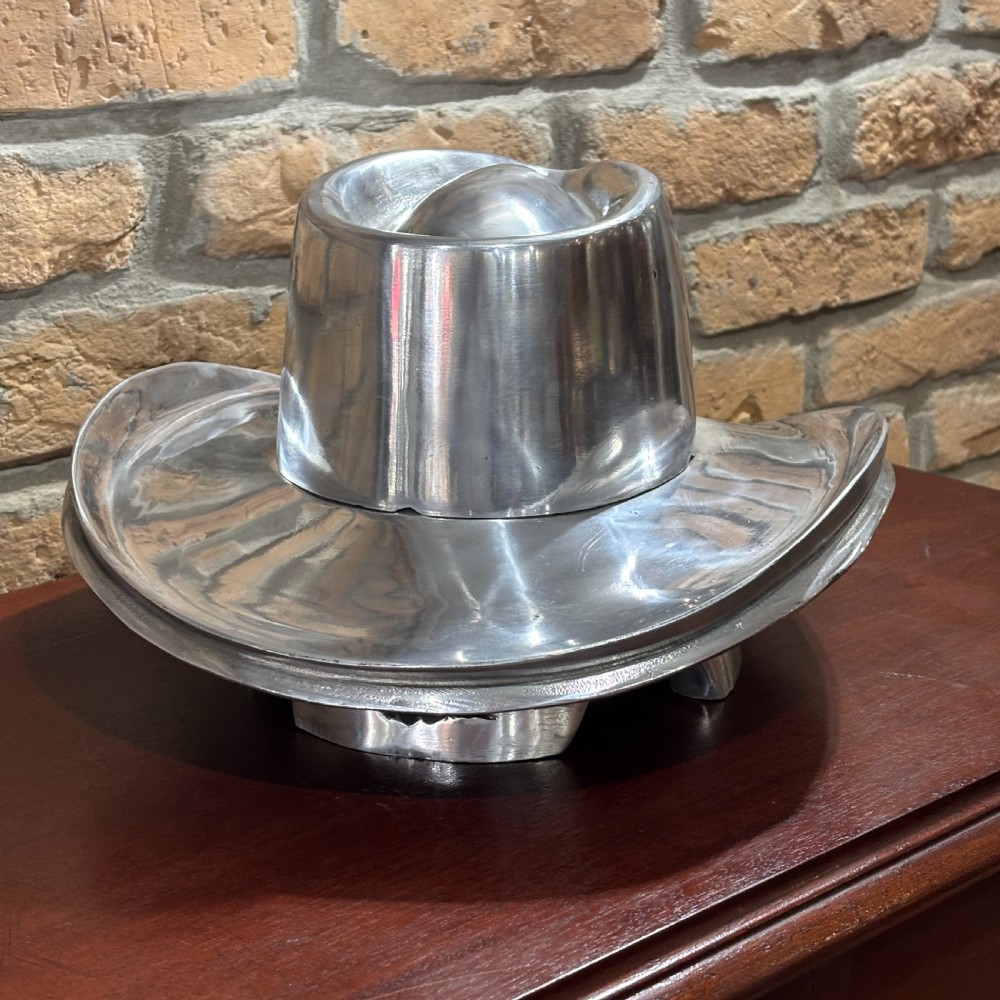 A polished silver aluminium milliners hat block mould shaped in a fedora brim silhouette. View II