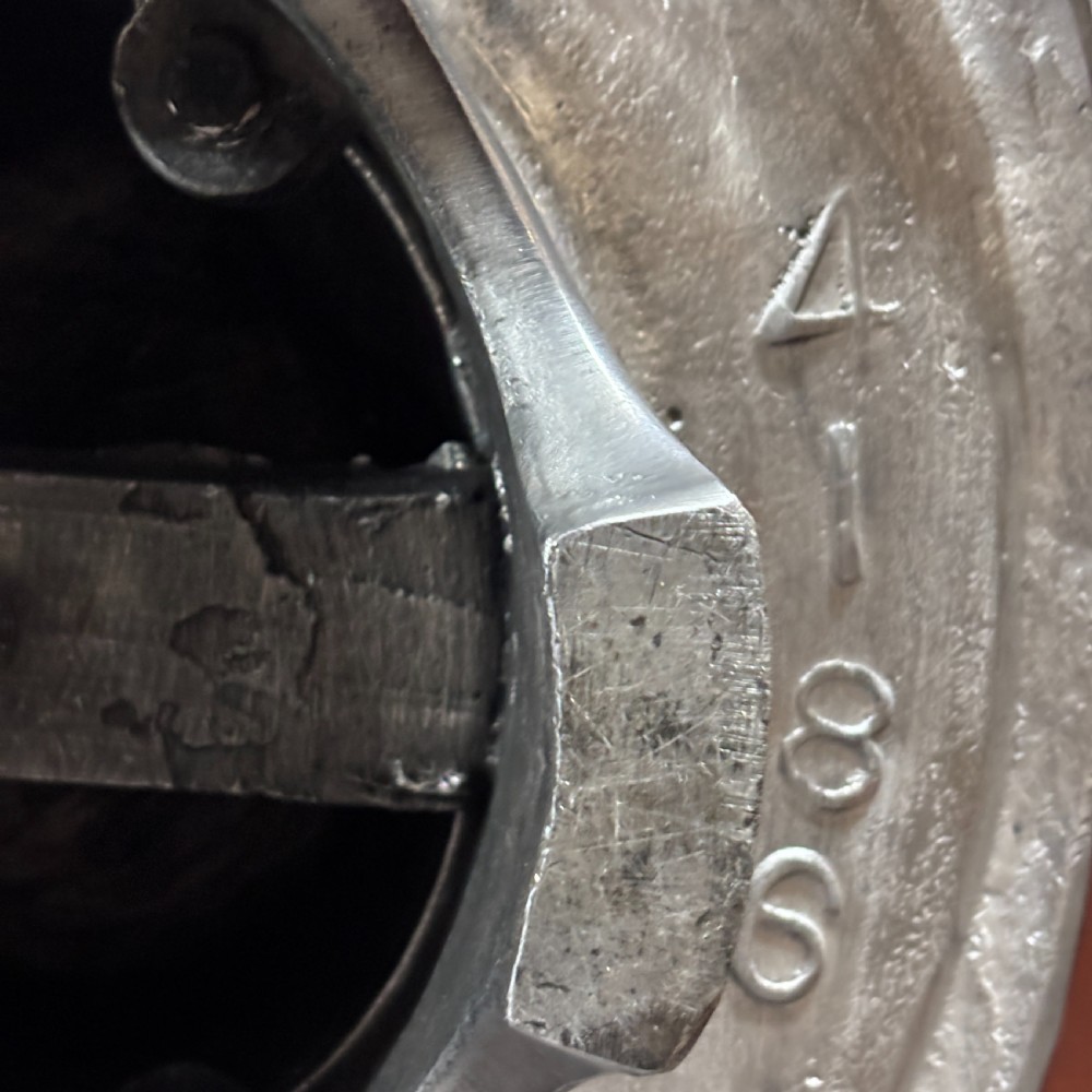 A polished silver aluminium milliners hat block mould shaped in a fedora brim silhouette. View VI