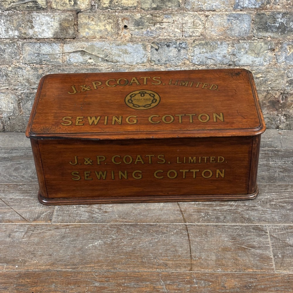 An antique wooden J. & P. Coats countertop drawer unit with stencilled lettering on the drawers and top surface. View IV