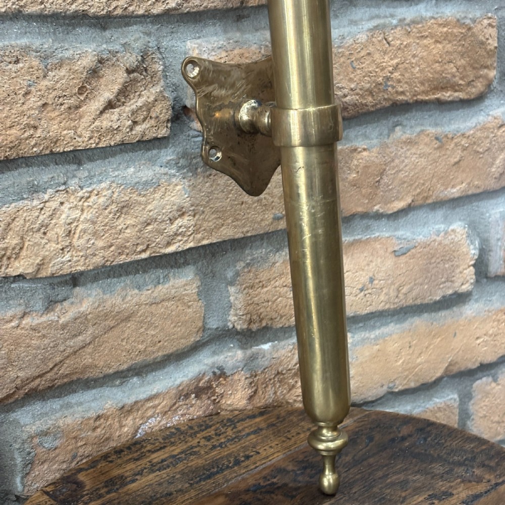 A pair of long, vertical antique brass door pull handles featuring turned urn finials at the top and mounting brackets. View III