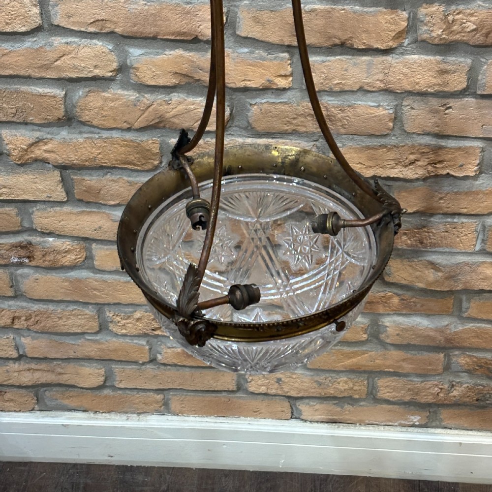 A late Victorian ceiling pendant light featuring a cut glass bowl suspended by three curved bronze rods attached to a central top ring. View II
