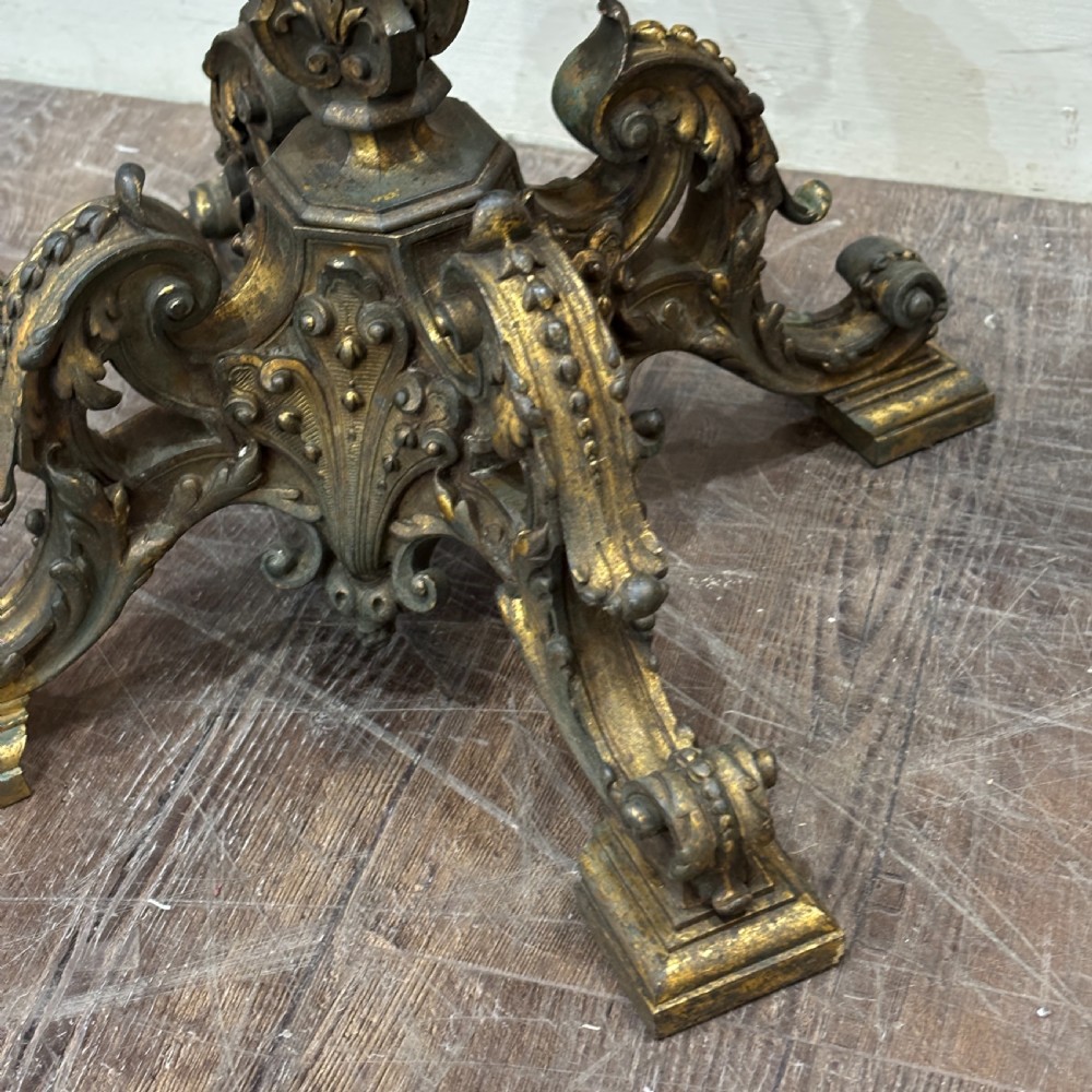 A pair of late Victorian gilt bronze lamp bases featuring ornate scrolling foliate designs, tripod feet, and raised brass light sockets. View II