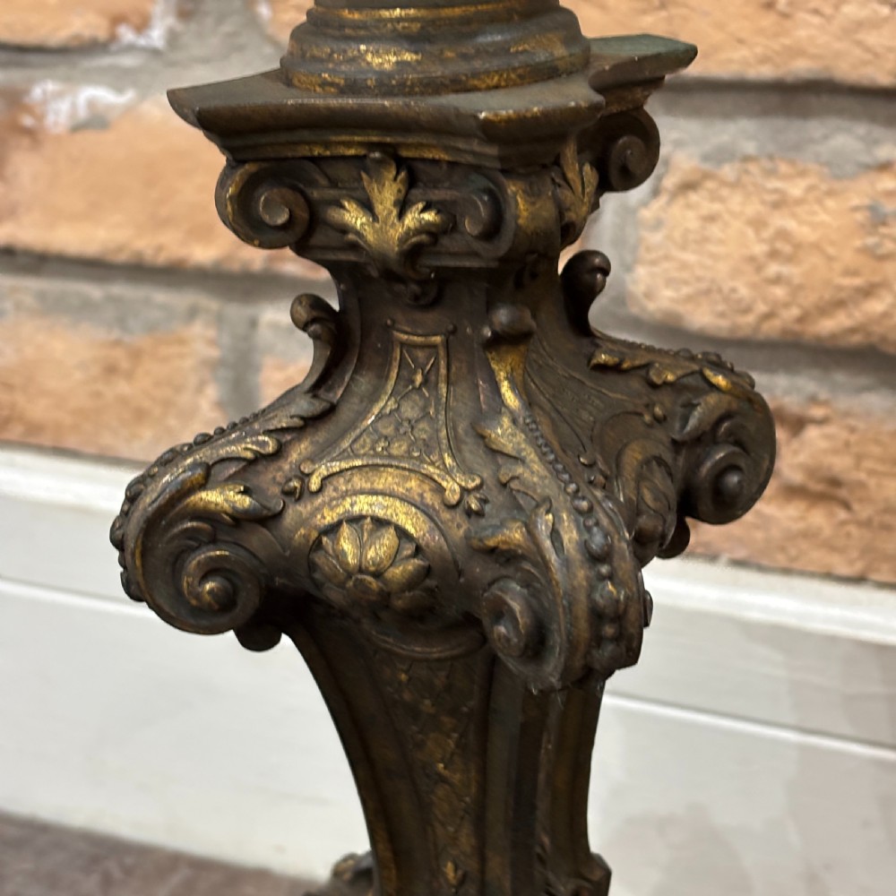A pair of late Victorian gilt bronze lamp bases featuring ornate scrolling foliate designs, tripod feet, and raised brass light sockets. View III