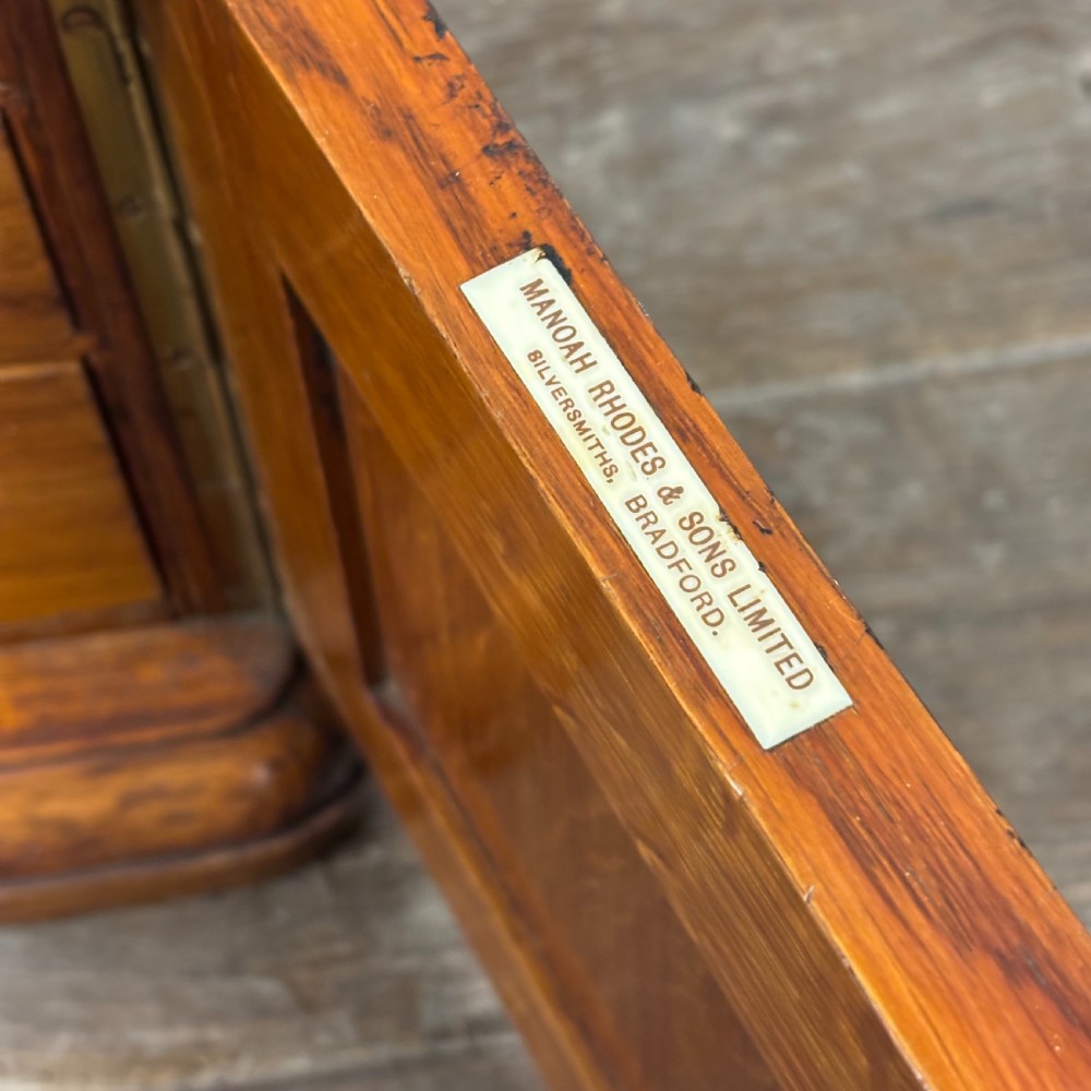An antique carved oak tabletop cabinet featuring twin doors decorated with carved trade lettering and an illustration of a hare. View V