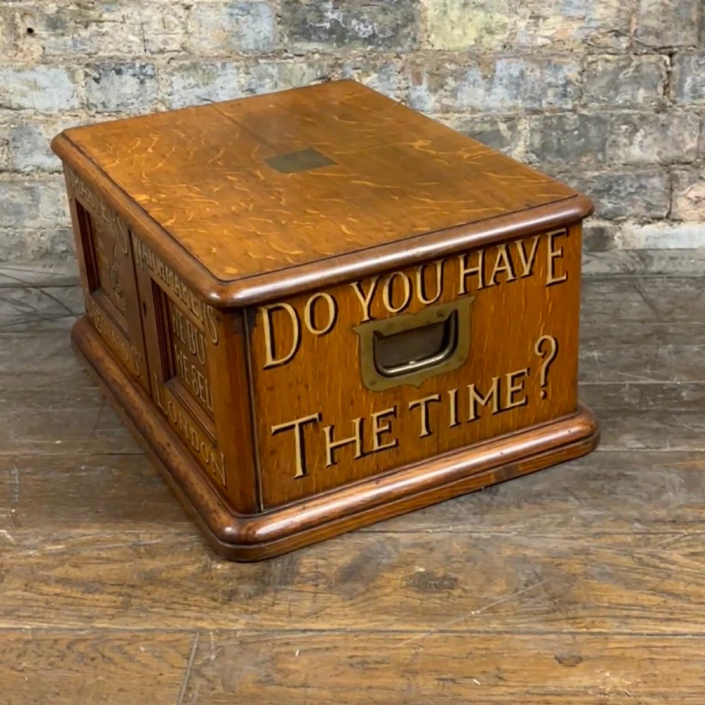 An antique carved oak tabletop cabinet featuring twin doors decorated with carved trade lettering and an illustration of a hare. View VI