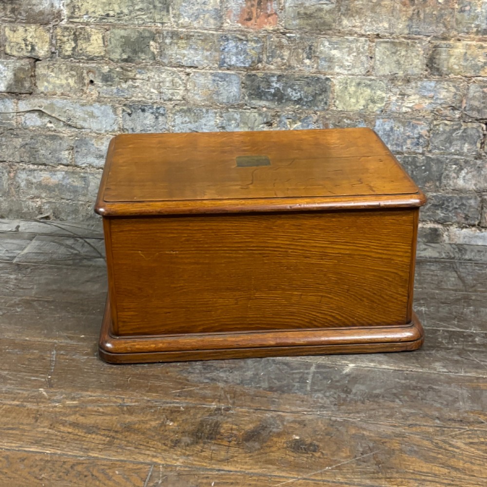 An antique carved oak tabletop cabinet featuring twin doors decorated with carved trade lettering and an illustration of a hare. View VII