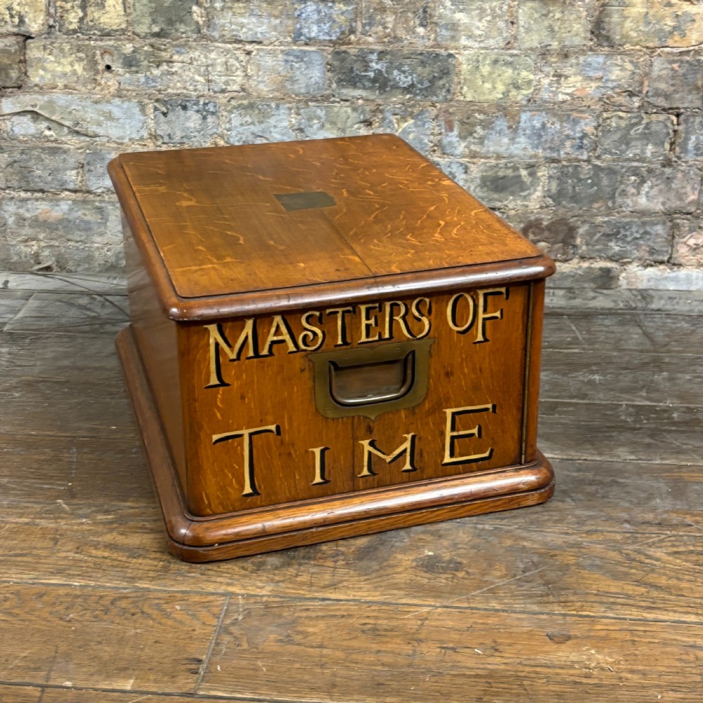 An antique carved oak tabletop cabinet featuring twin doors decorated with carved trade lettering and an illustration of a hare. View VIII
