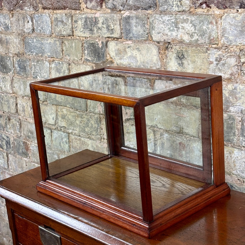 A rectangular 1920s countertop display cabinet featuring a polished mahogany frame with clear glass panels on all sides. View II