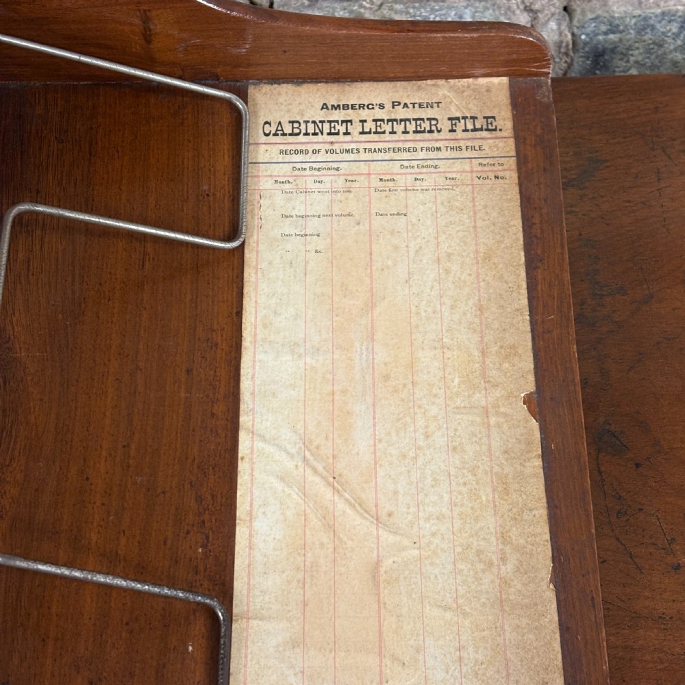 An Edwardian oak Ambergs patent letter filing cabinet featuring three vertical columns of ten small drawers fitted with brass label holders. View VIII