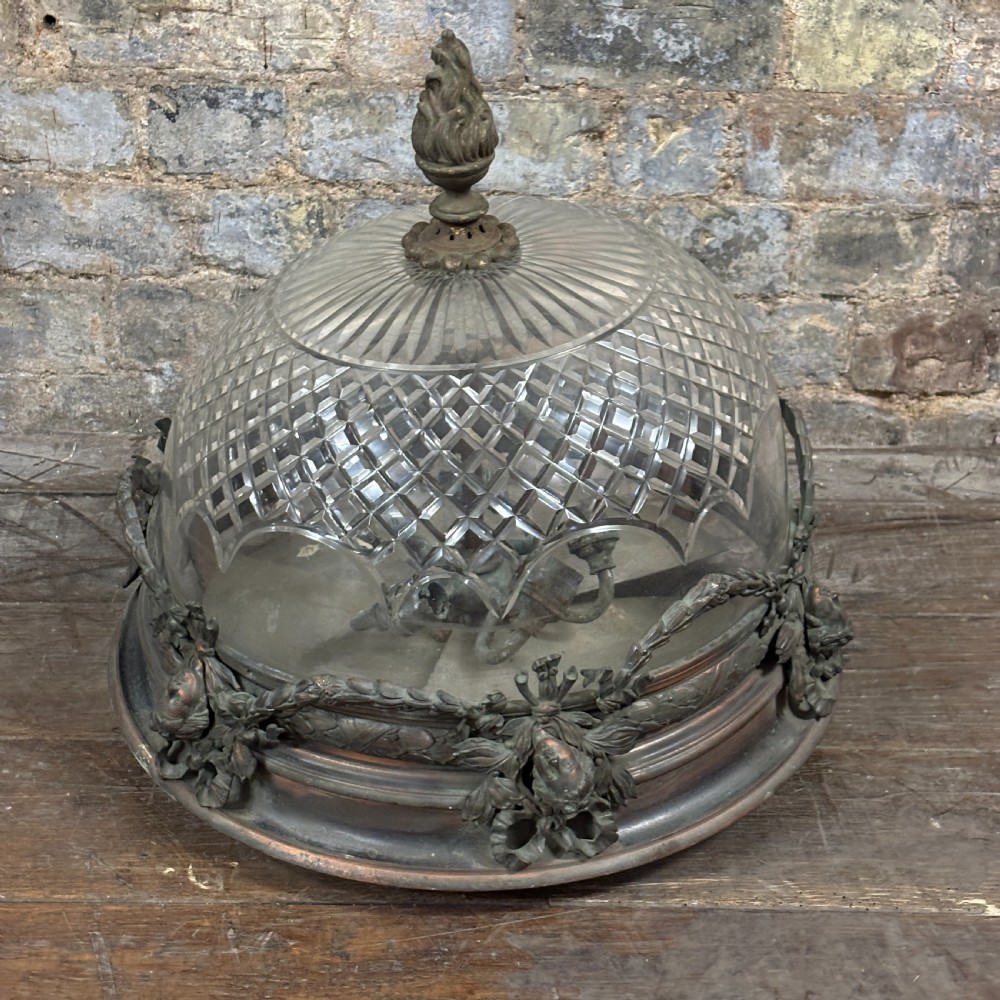 An early 1900s dome-shaped cut glass light fitting featuring diamond lattice pattern glass and a patinated bronze mount with floral swag ornamentation.