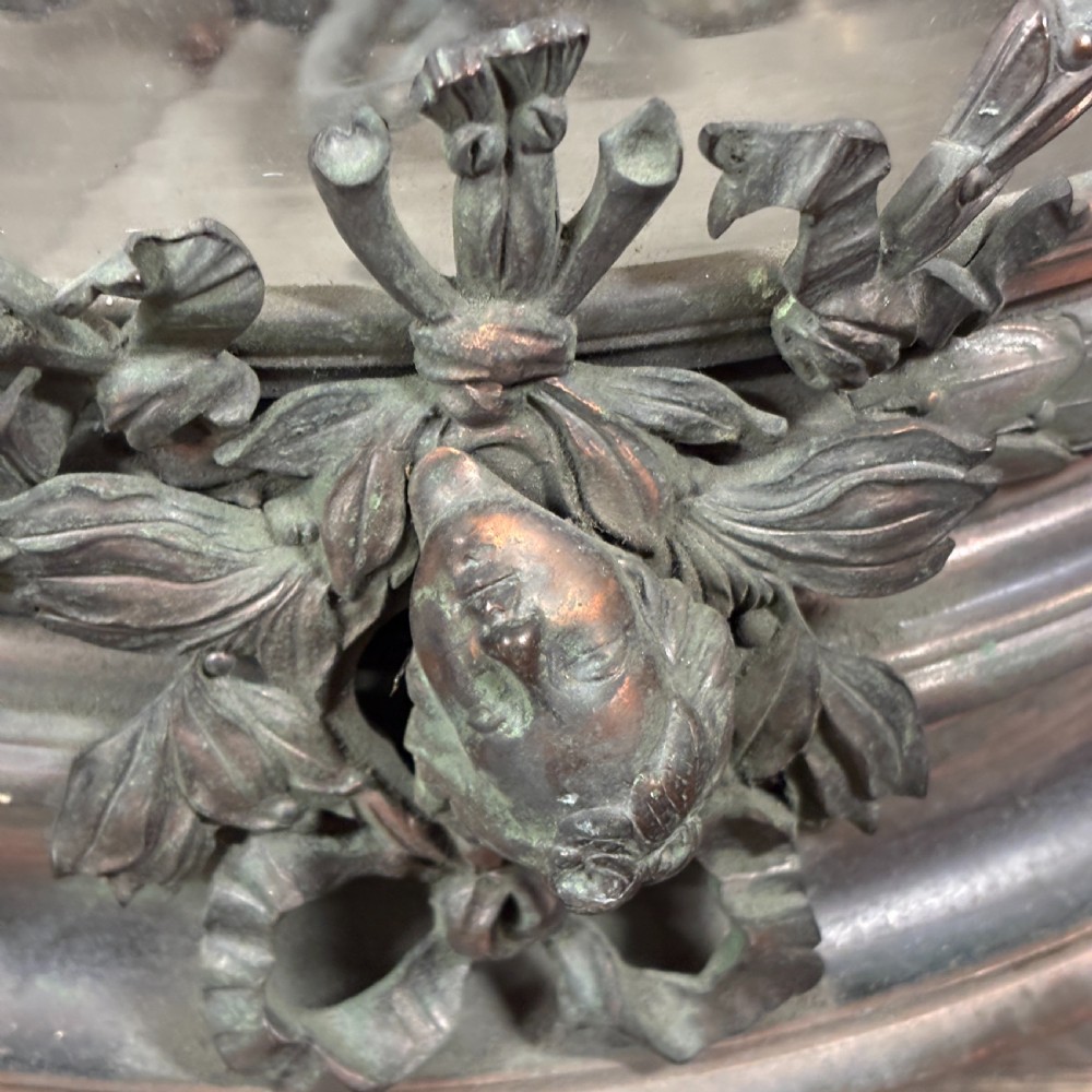 An early 1900s dome-shaped cut glass light fitting featuring diamond lattice pattern glass and a patinated bronze mount with floral swag ornamentation. View II