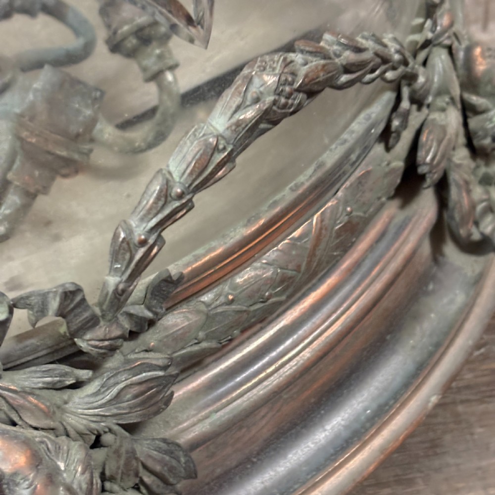 An early 1900s dome-shaped cut glass light fitting featuring diamond lattice pattern glass and a patinated bronze mount with floral swag ornamentation. View IV