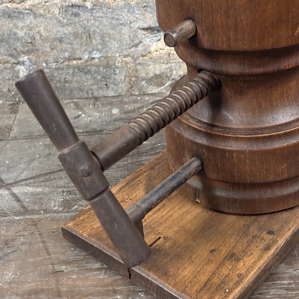 A late 19th-century wooden hat stretcher featuring a split two-part head mounted on a rectangular base with a metal screw-thread mechanism. View III