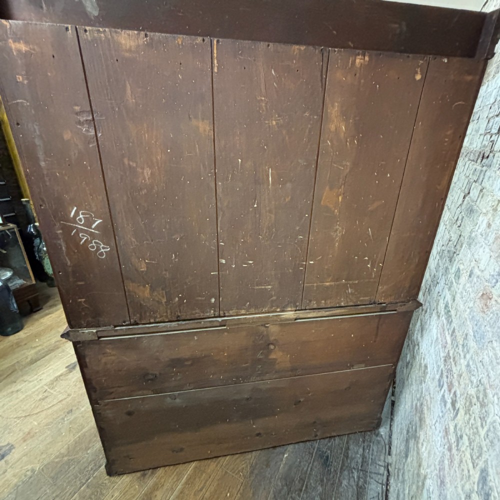 A late Victorian oak cabinet with pointed Gothic arch moulding on two upper panelled doors, two middle drawers, and a lower double-door cupboard. View III