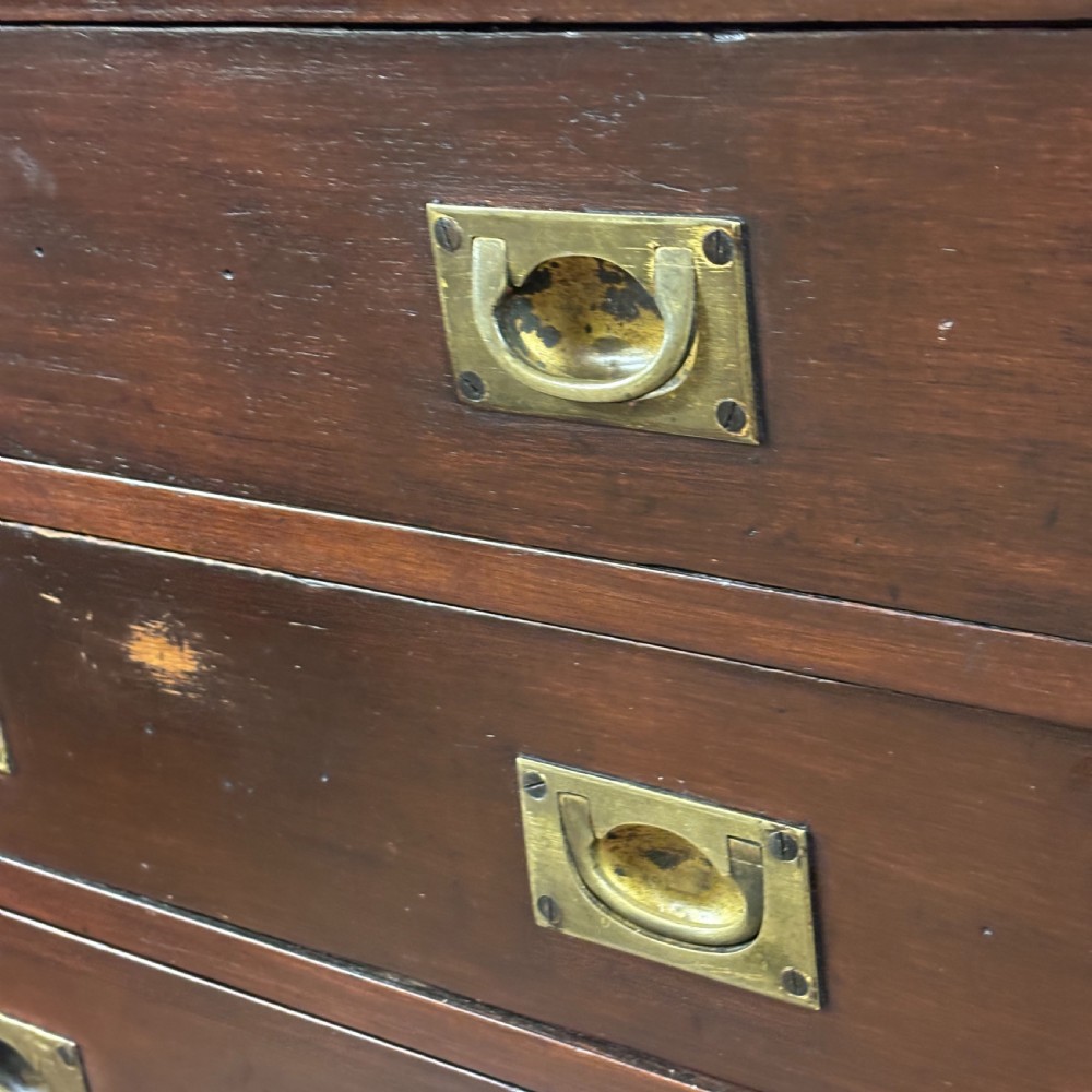 A 1920s mahogany bank of ten drawers featuring inset brass campaign handles and a solid plinth base. View III