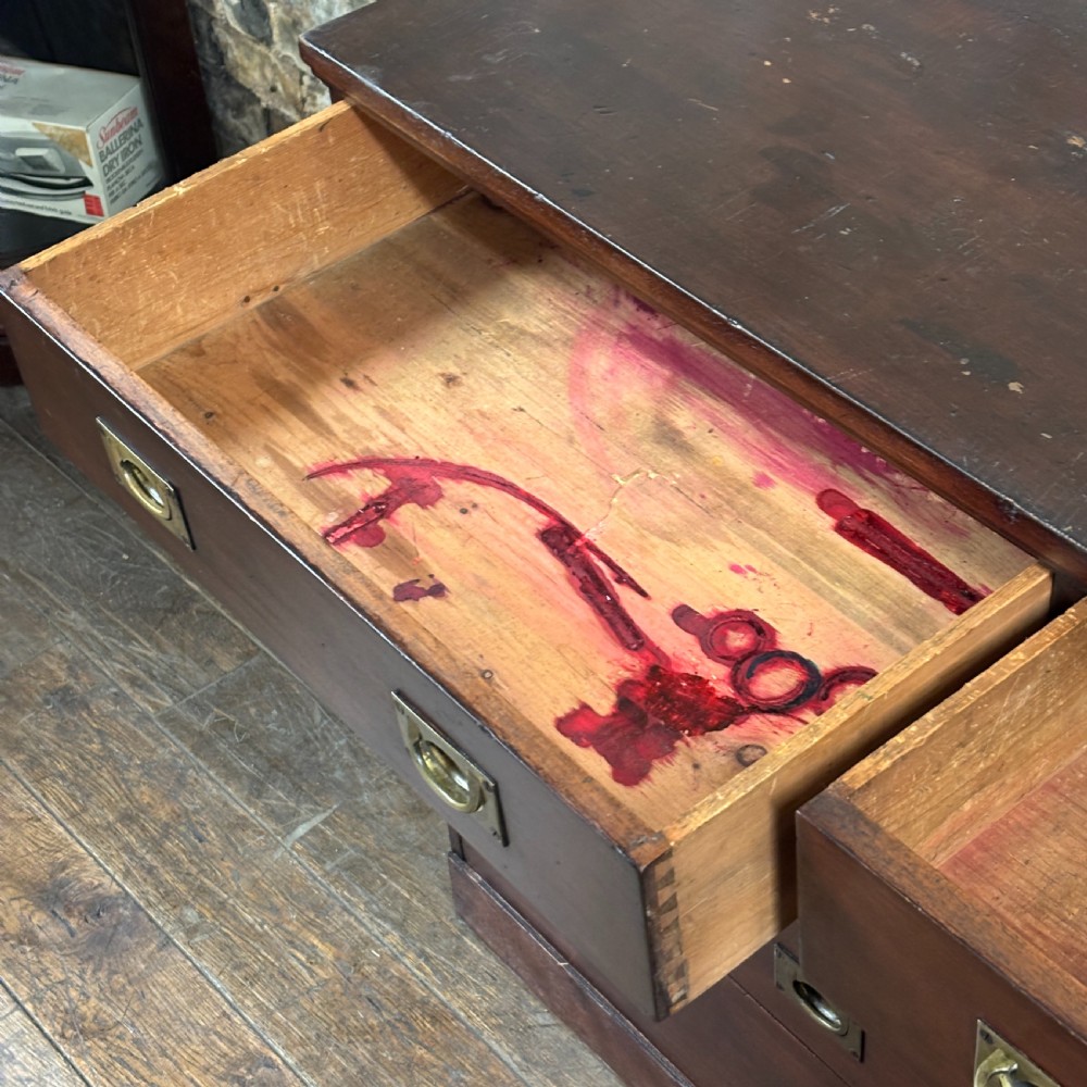 A 1920s mahogany bank of ten drawers featuring inset brass campaign handles and a solid plinth base. View IV