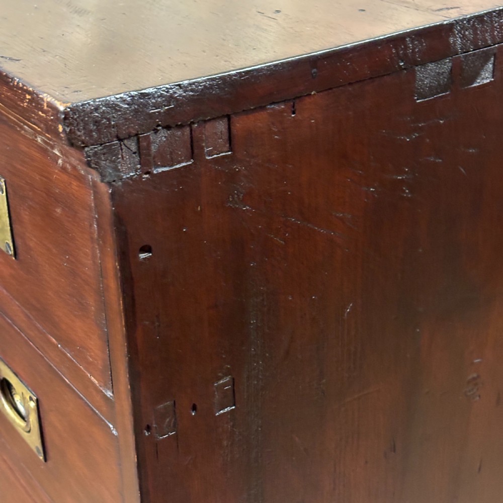 A 1920s mahogany bank of ten drawers featuring inset brass campaign handles and a solid plinth base. View VI
