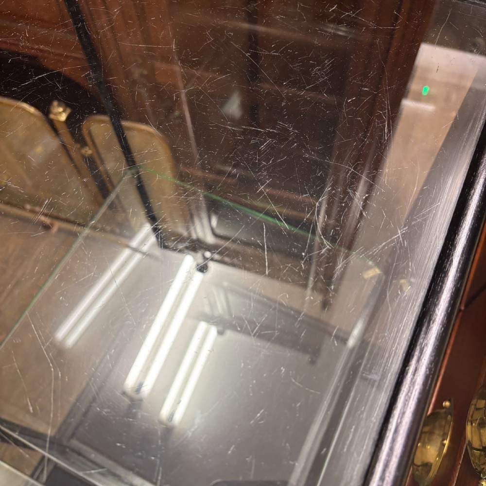 A vertical ebonised wooden countertop display cabinet featuring glazed sides, a central glass shelf, and a mirrored back. View VII
