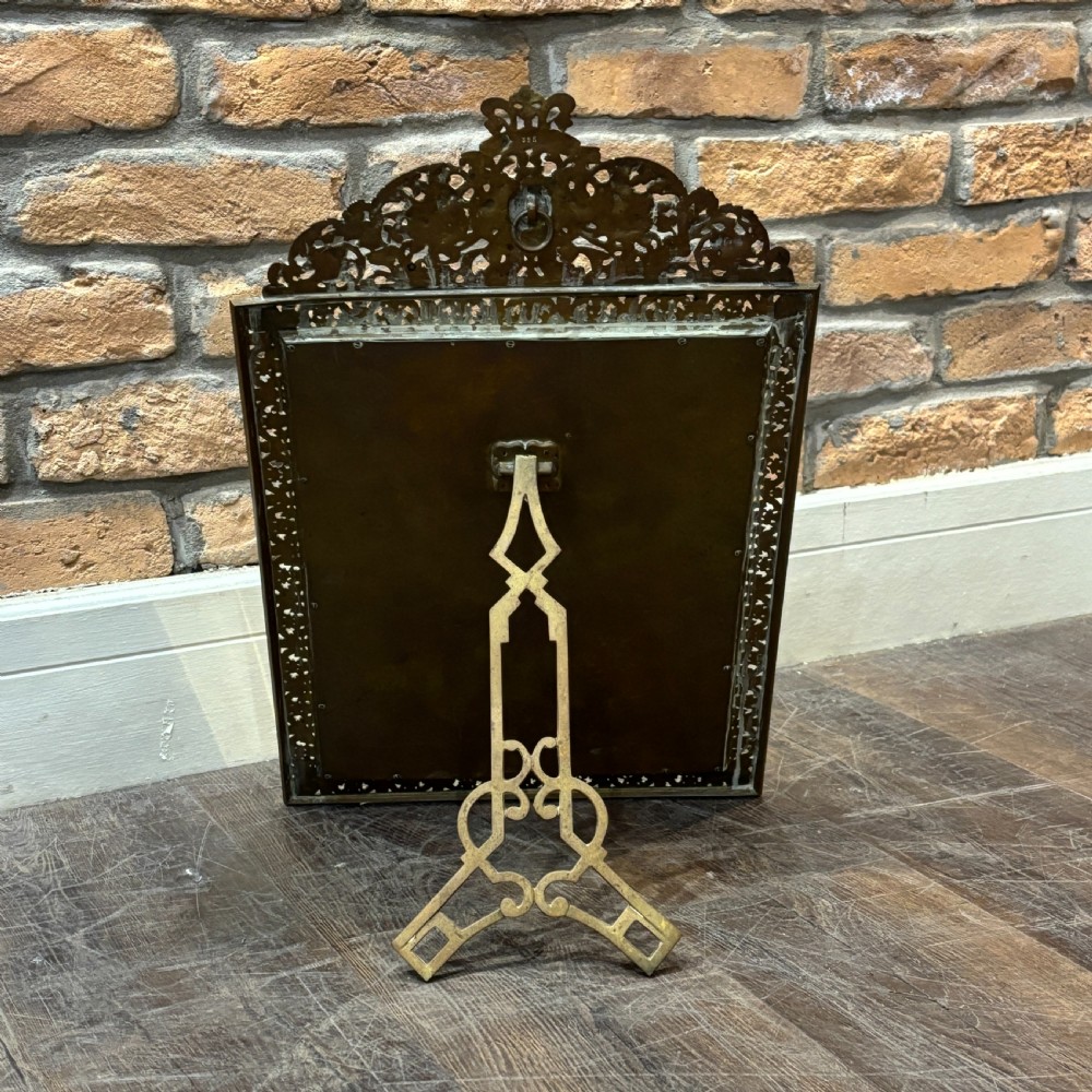 An ornate late nineteenth-century French brass table mirror featuring a crowned crest, relief scrollwork border, and a rectangular bevelled glass plate. View III