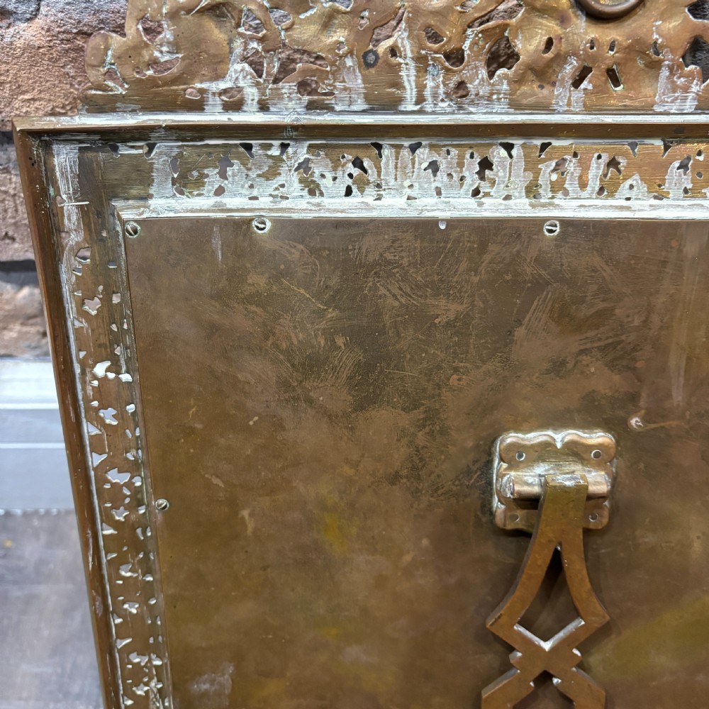 An ornate late nineteenth-century French brass table mirror featuring a crowned crest, relief scrollwork border, and a rectangular bevelled glass plate. View VII