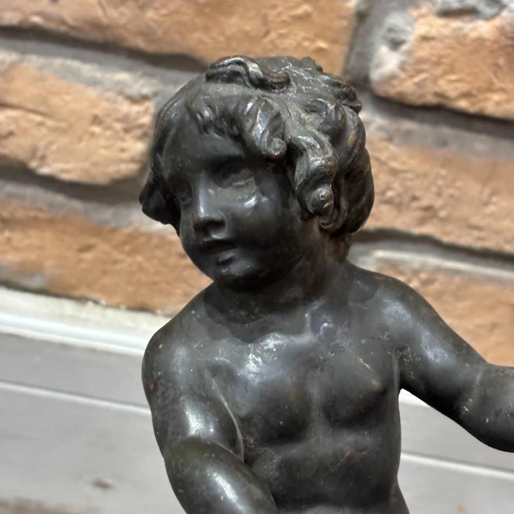 A pair of dark patinated bronze torchere table lamps featuring sculpted cherub figures mounted on decorative square bases. View VII